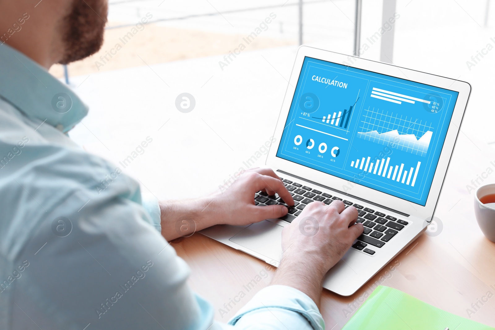 Image of Value concept. Man working with laptop at table indoors, closeup