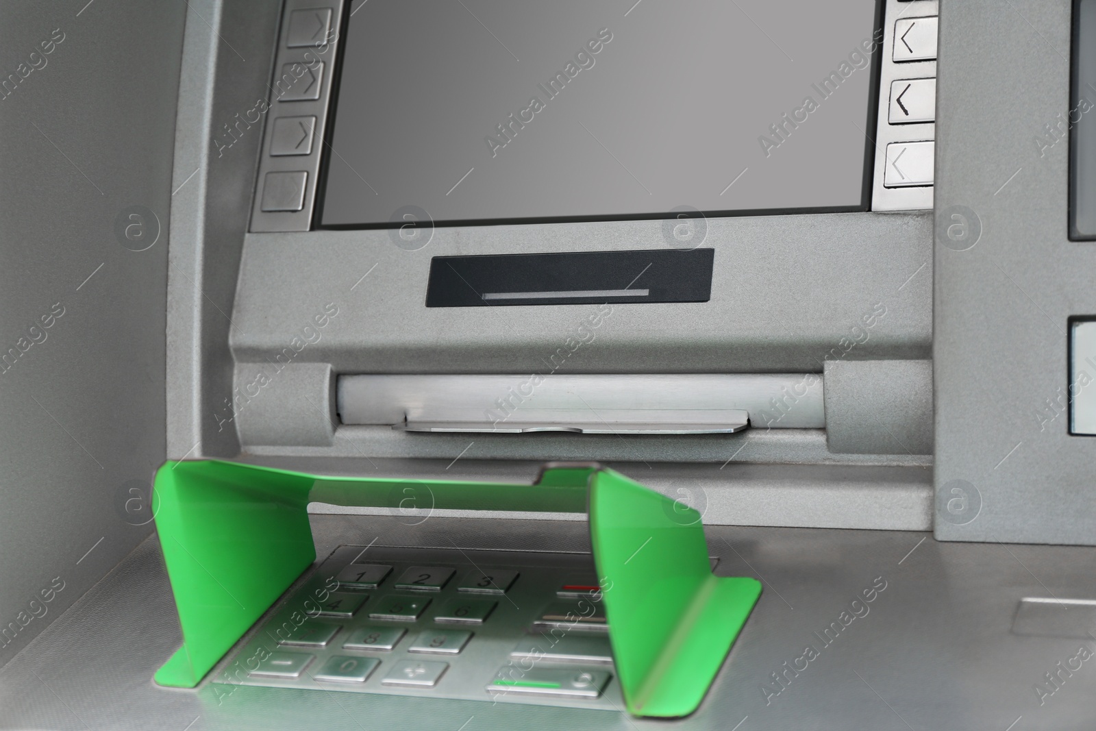 Photo of Modern automated cash machine with screen and keypad