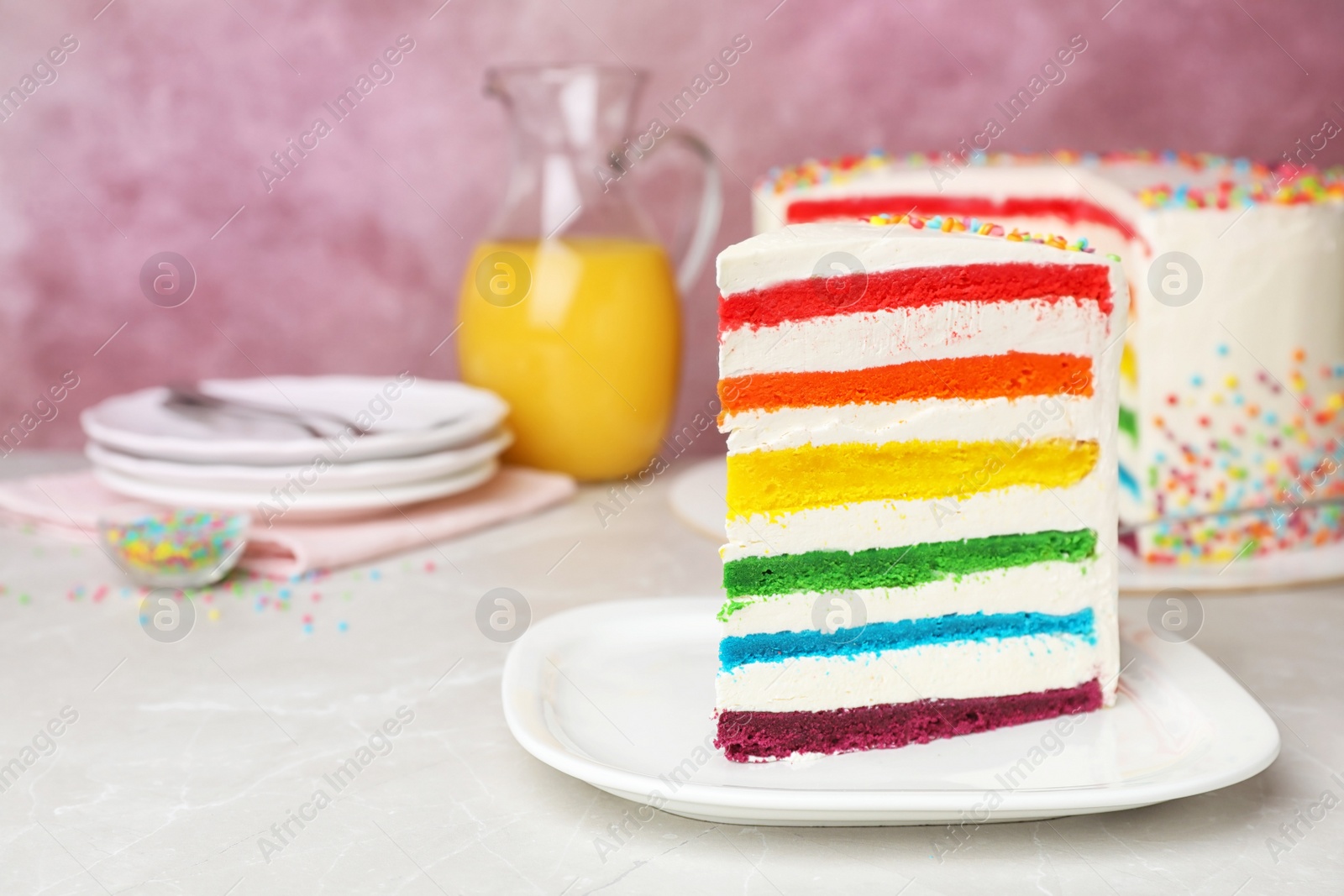 Photo of Delicious rainbow cake for party on table