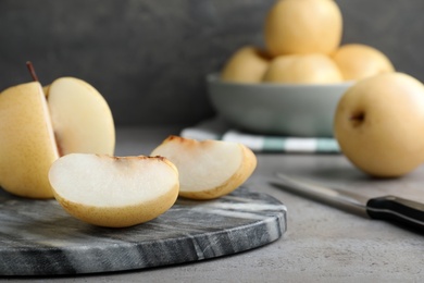 Photo of Cut fresh apple pear on grey table