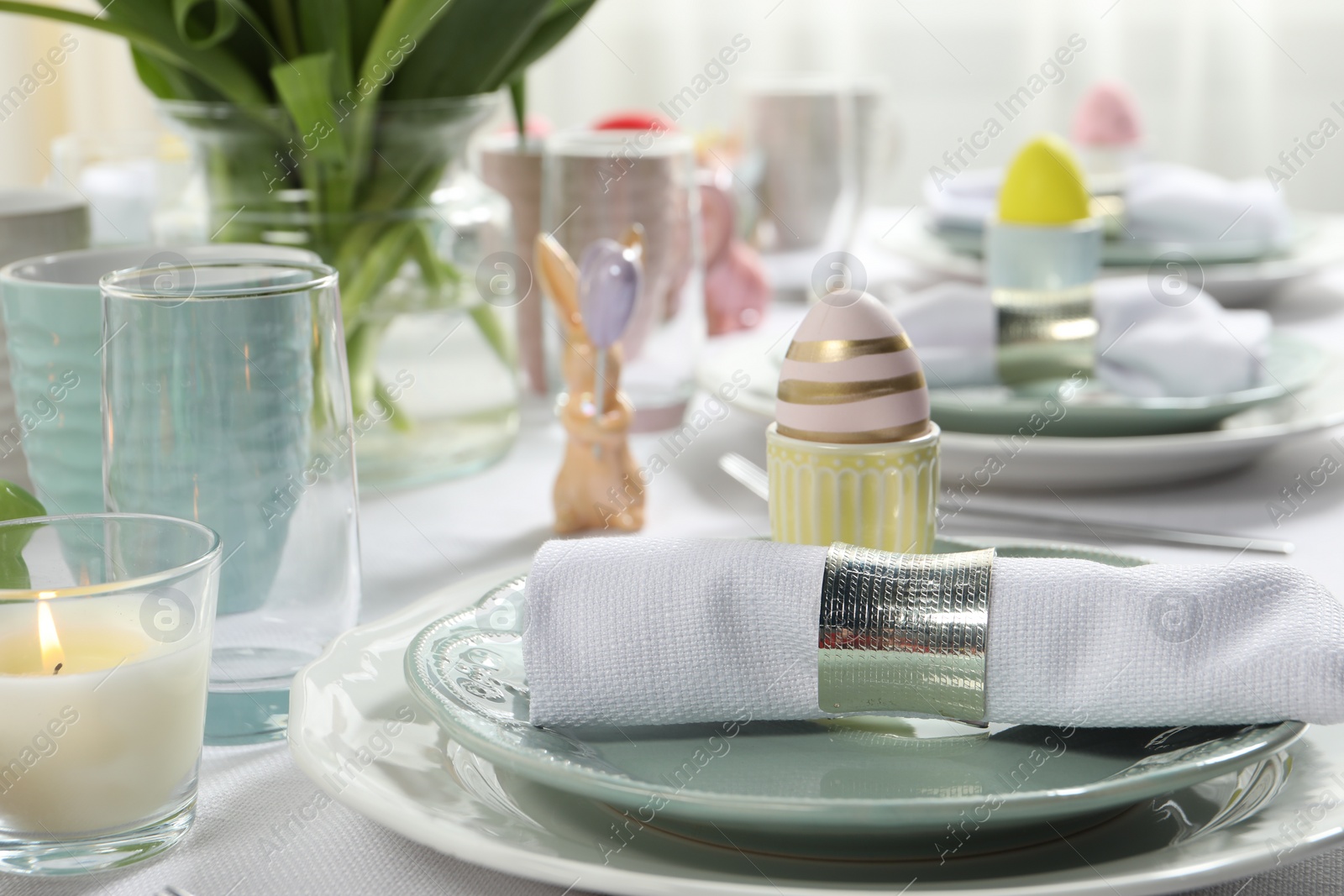 Photo of Easter celebration. Festive table setting with painted eggs.