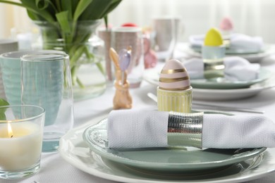 Easter celebration. Festive table setting with painted eggs.