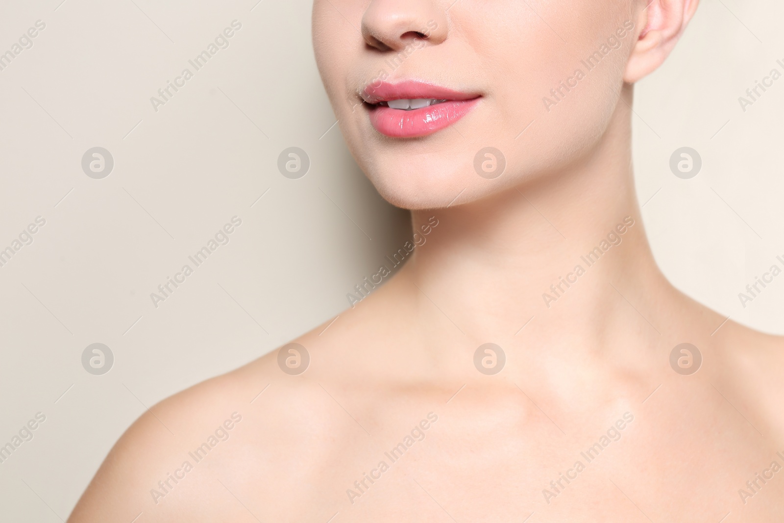 Photo of Beautiful young woman with perfect lips makeup on light background, closeup