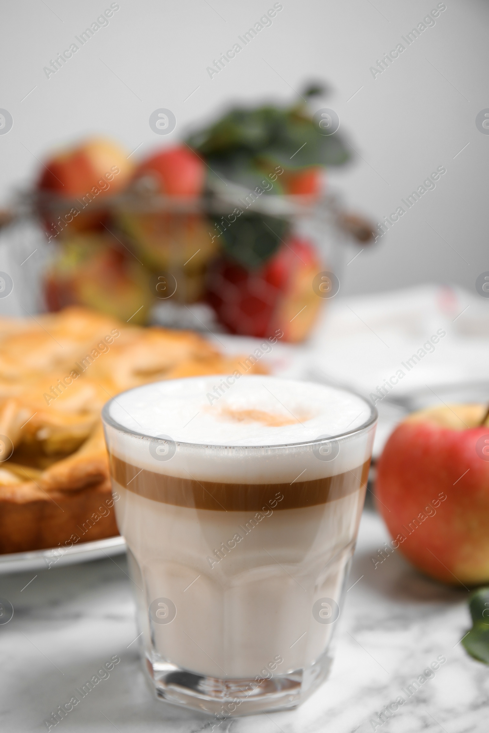 Photo of Glass of coffee and traditional apple pie on white marble table