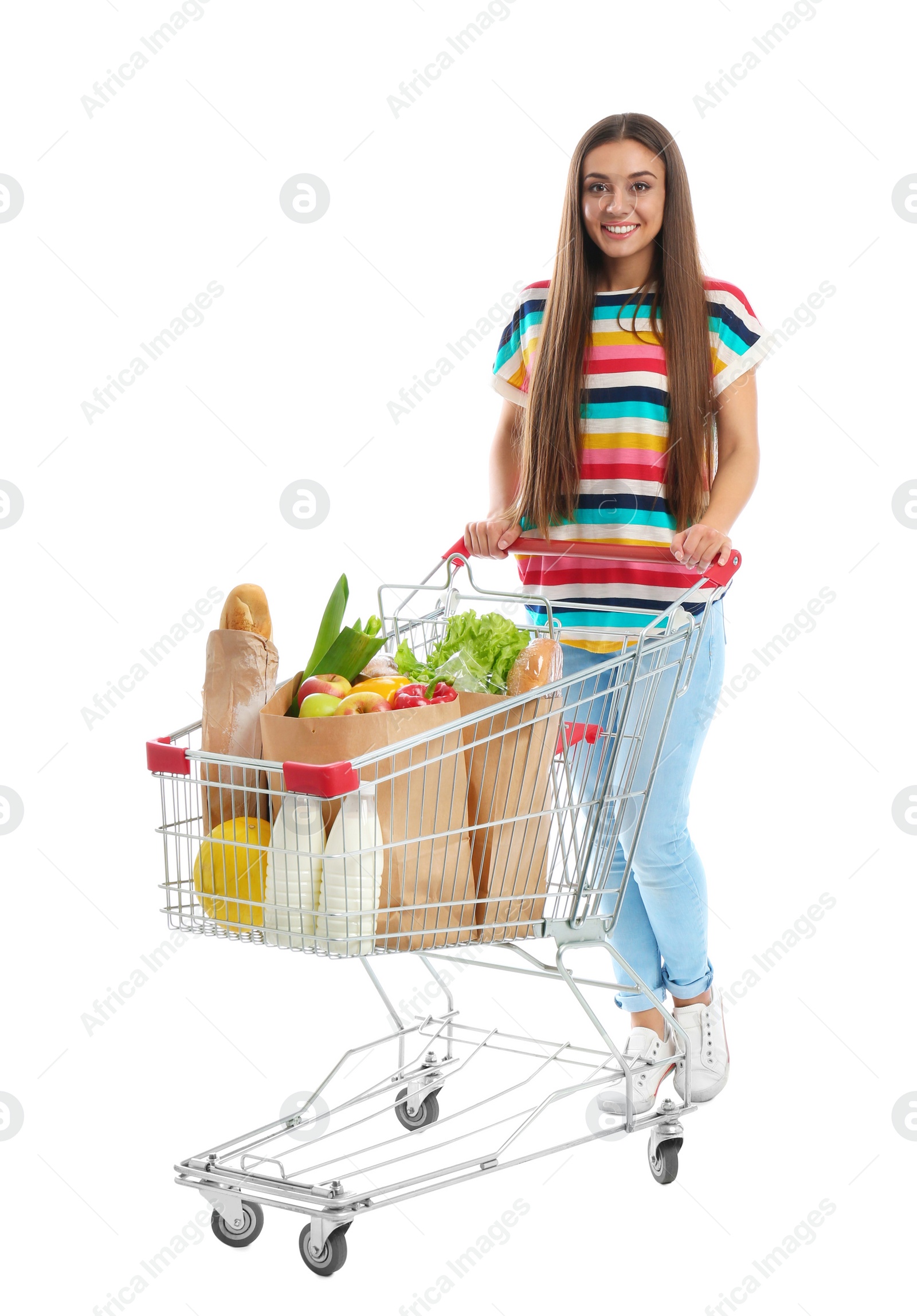 Photo of Young woman with full shopping cart on white background