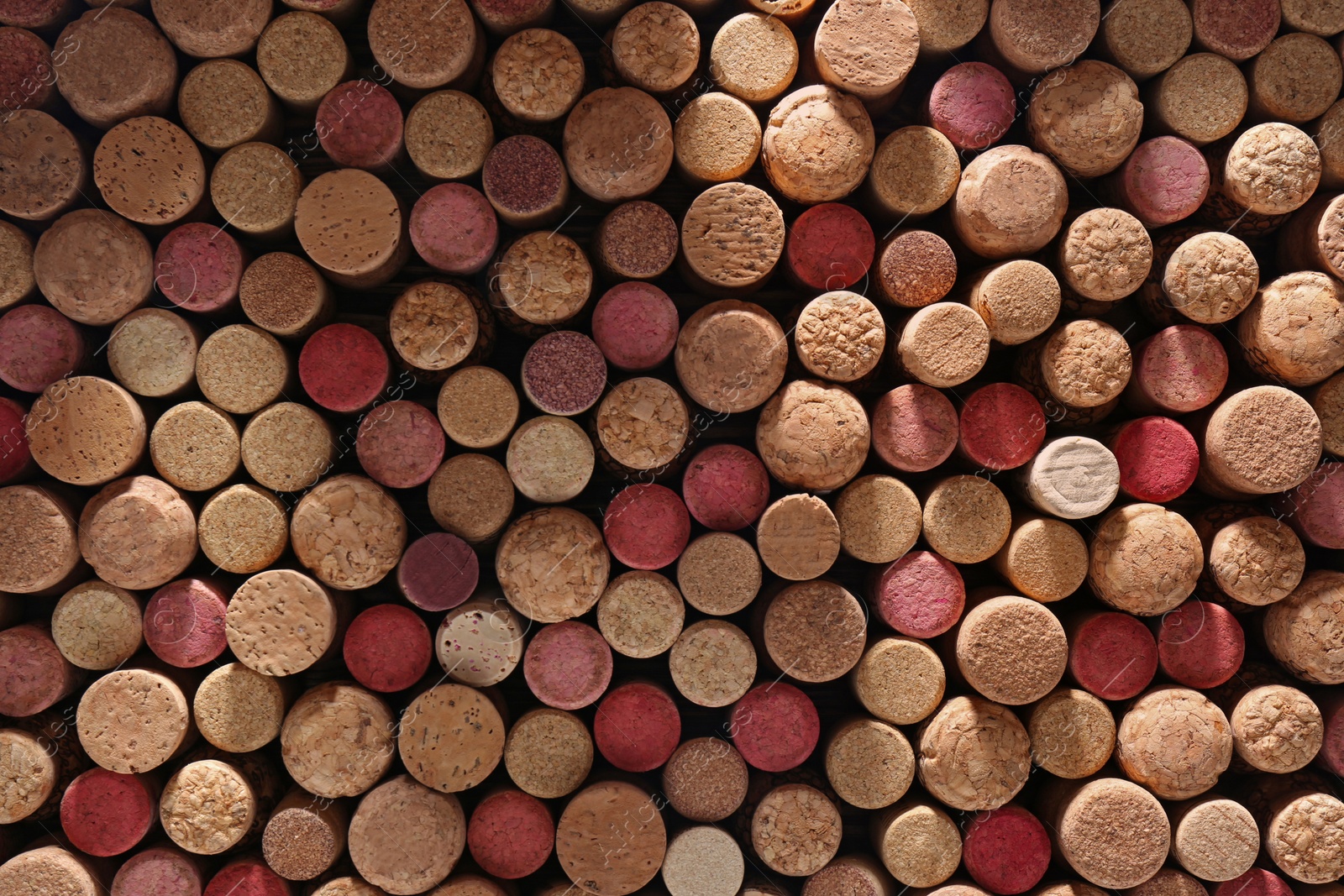 Photo of Many corks of wine bottles as background, top view