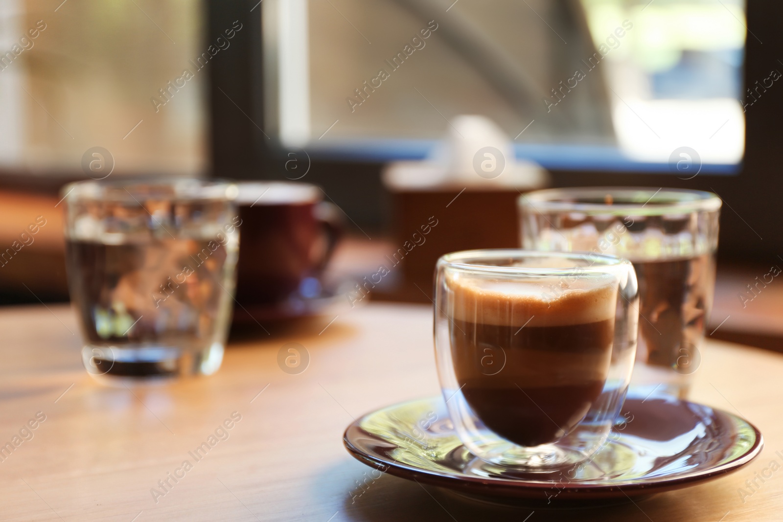 Photo of Aromatic coffee on wooden table in cafe. Space for text