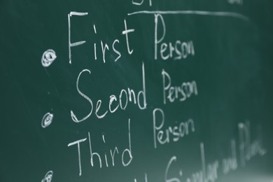 English grammar rules written with chalk on green board, closeup