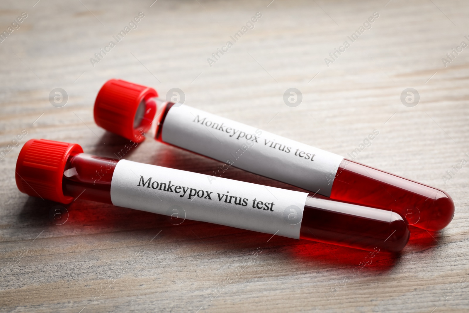 Photo of Monkeypox virus test. Sample tubes with blood on wooden table
