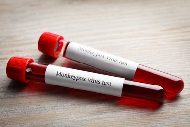 Monkeypox virus test. Sample tubes with blood on wooden table