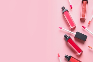 Photo of Beautiful flat lay composition of liquid lipsticks and space for text on color background