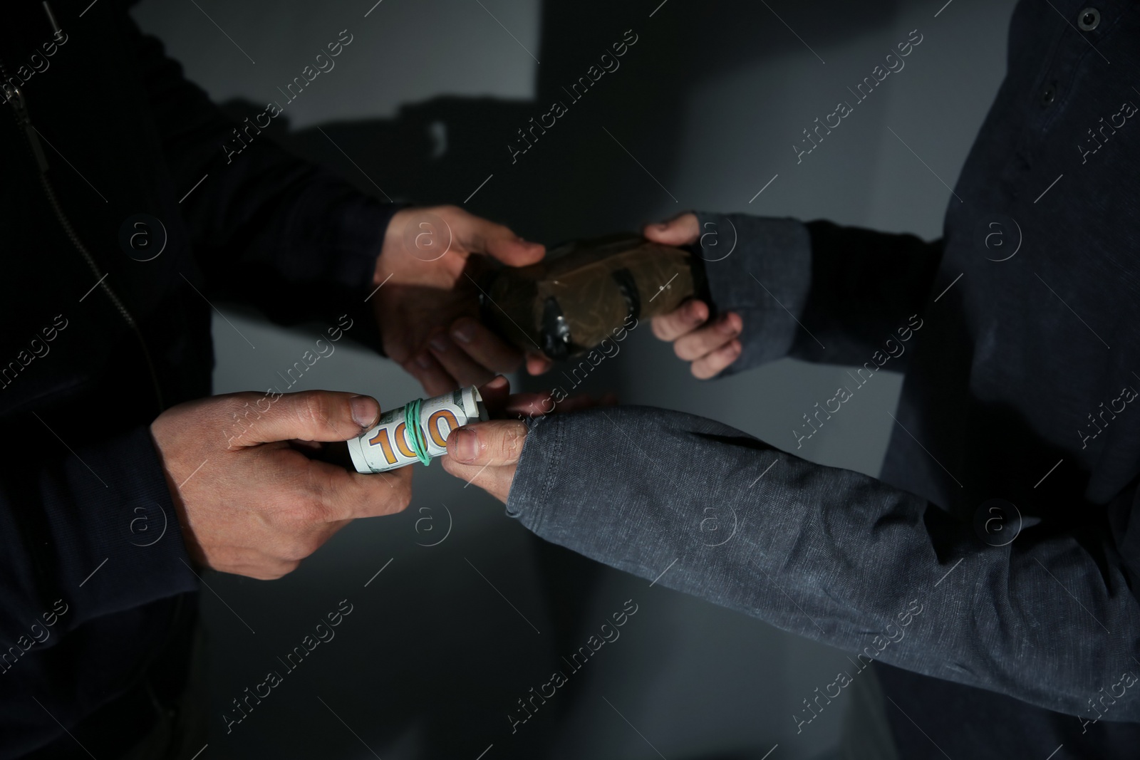 Photo of Addicted man buying drugs from dealer on grey background