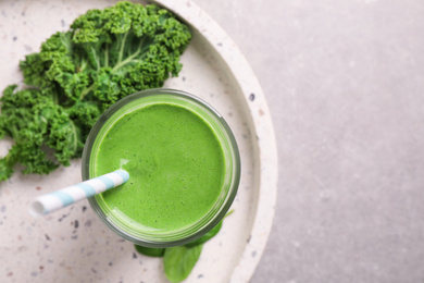 Photo of Tasty kale smoothie on light grey marble table, top view. Space for text