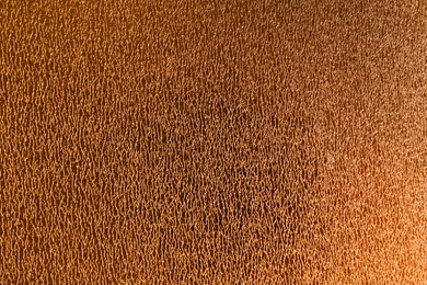 Photo of Golden textured surface as background, closeup view