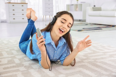 Beautiful young woman listening to music on mobile phone