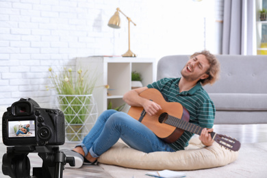 Music teacher recording guitar lesson at home