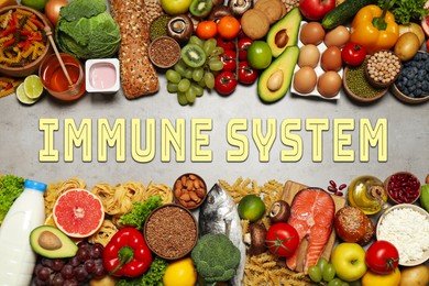 Image of Immune system boosting with proper nutrition. Different foods on grey table, flat lay