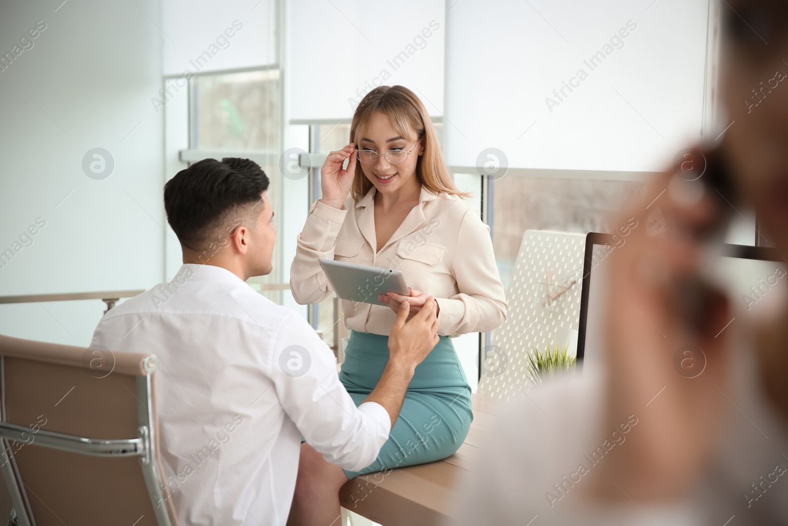 Photo of Colleagues flirting with each other during work in office