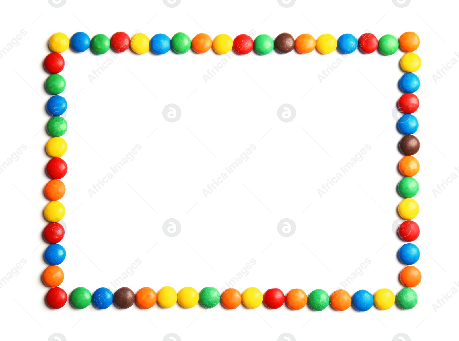 Photo of Frame made of colorful candies on white background, top view. Space for text