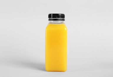 Bottle with delicious fresh juice on light background