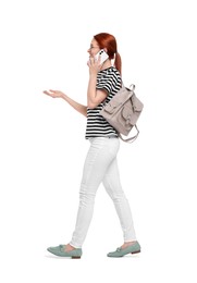 Photo of Happy woman with backpack talking on smartphone against white background