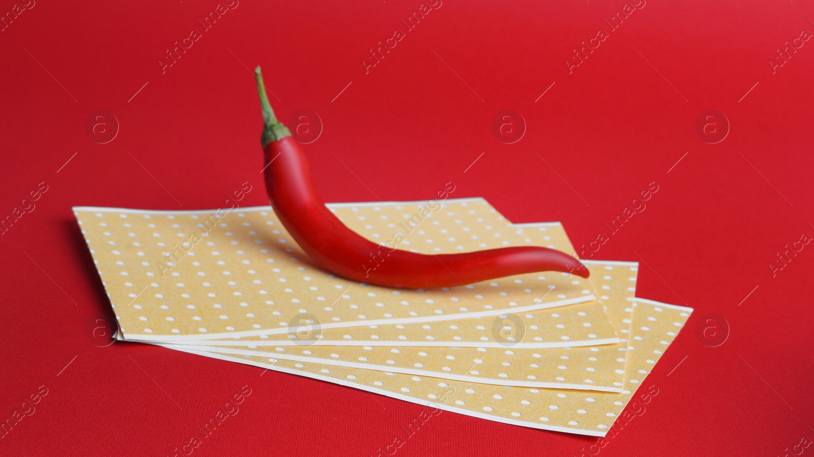 Photo of Pepper plasters and chili on red background. Alternative medicine