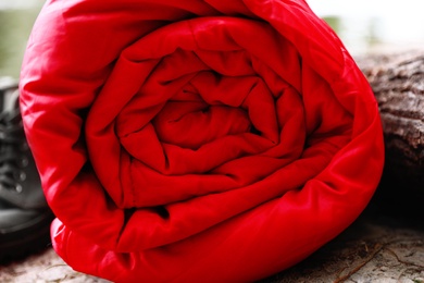 Photo of Rolled sleeping bag outdoors on sunny day, closeup