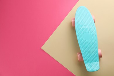 Photo of Turquoise skateboard on color background, top view. Space for text