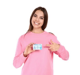 Happy young woman with driving license on white background