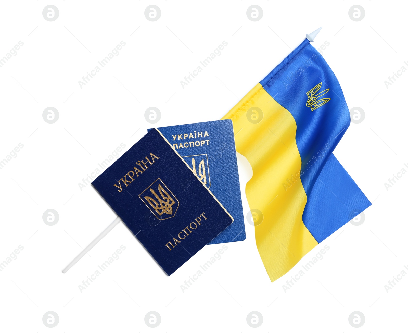 Photo of Ukrainian passports and national flag on white background, top view. International relationships