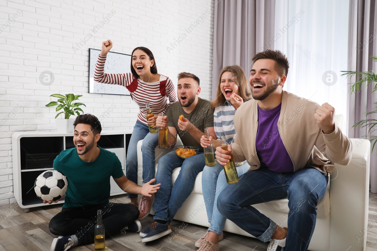 Photo of Group of friends watching football at home