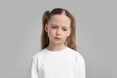 Photo of Portrait of sad girl on light grey background