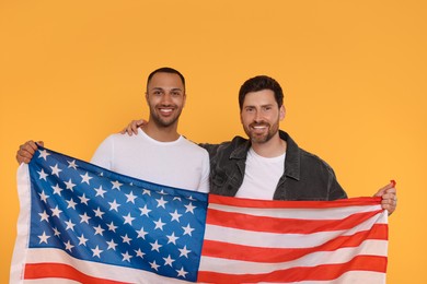 Photo of 4th of July - Independence Day of USA. Happy men with American flag on yellow background