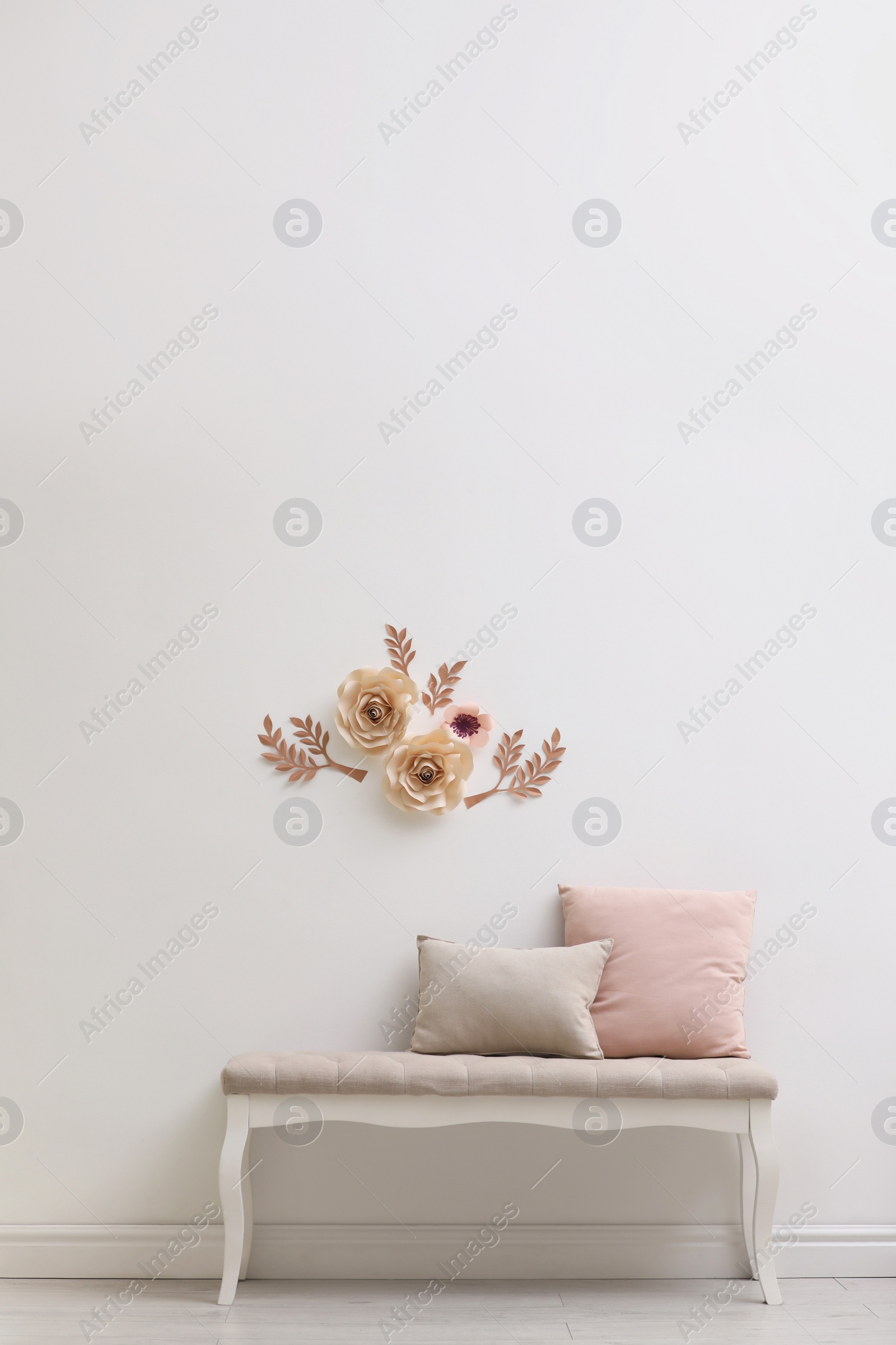 Photo of Stylish room interior with floral decor and comfortable  indoor bench