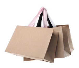 Photo of Paper shopping bags with handles on white background. Mockup for design