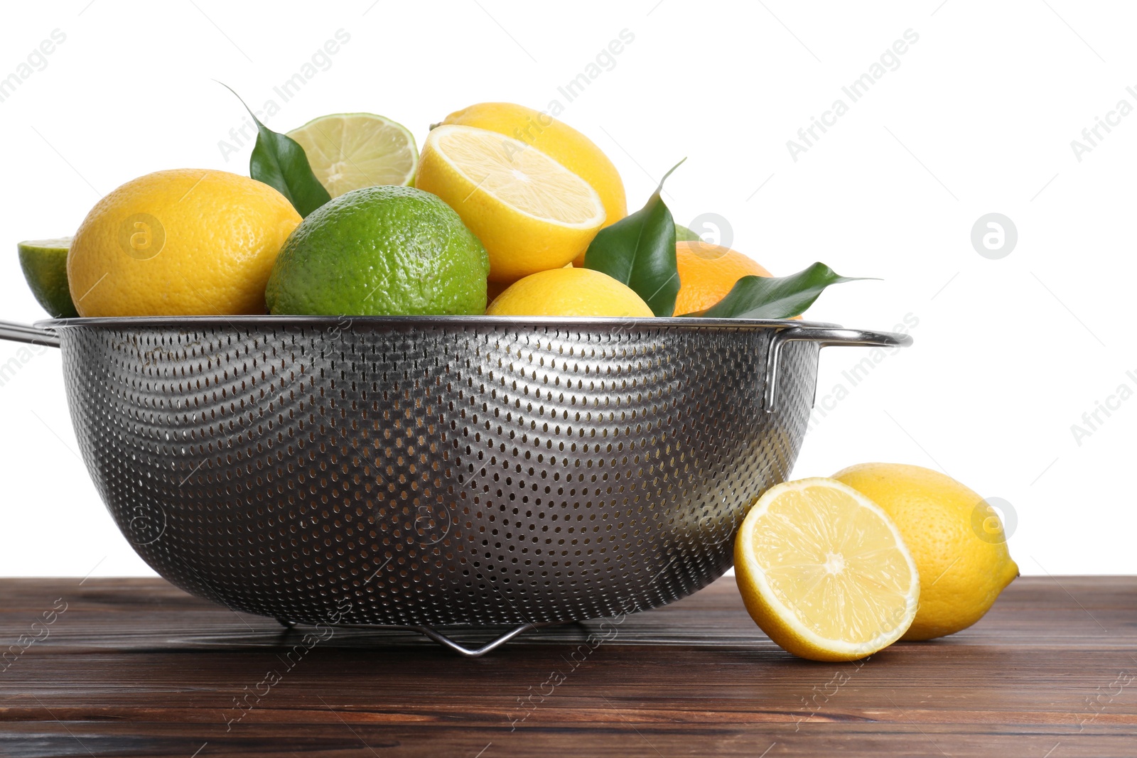 Photo of Metal colander with citrus fruits on wooden table against white background