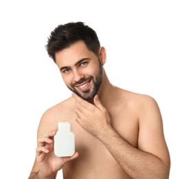 Photo of Handsome young man with beard holding post shave lotion on white background
