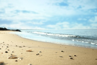 Beautiful sandy beach and sea under blue sky, closeup