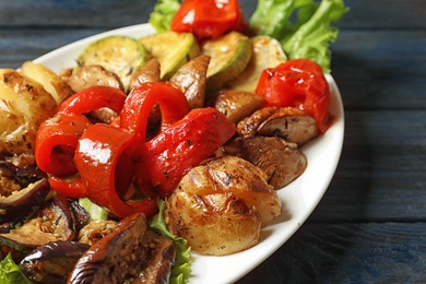 Photo of Plate with tasty grilled vegetables on table, closeup