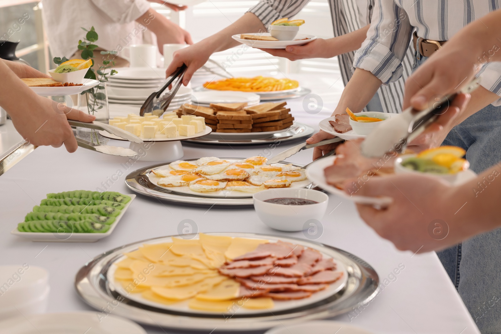 Photo of People taking food during breakfast, closeup. Buffet service