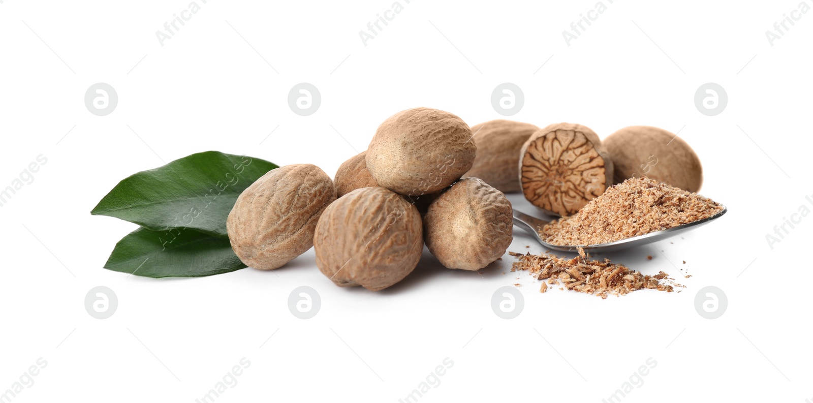 Photo of Grated nutmeg and seeds with green leaves on white background