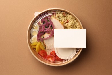 Tasty food in container on beige background, top view. Space for text