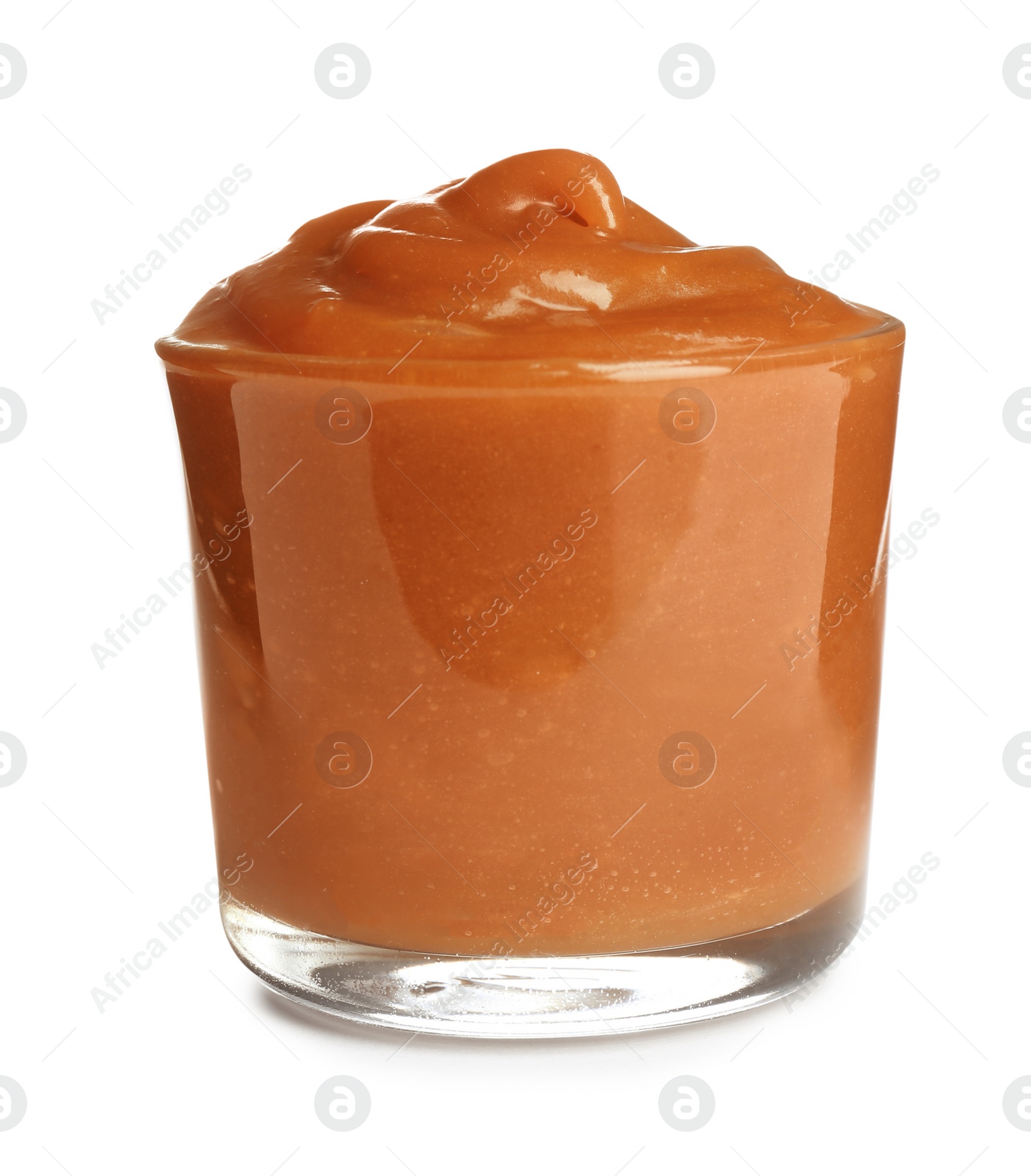 Photo of Glass of tasty caramel sauce isolated on white