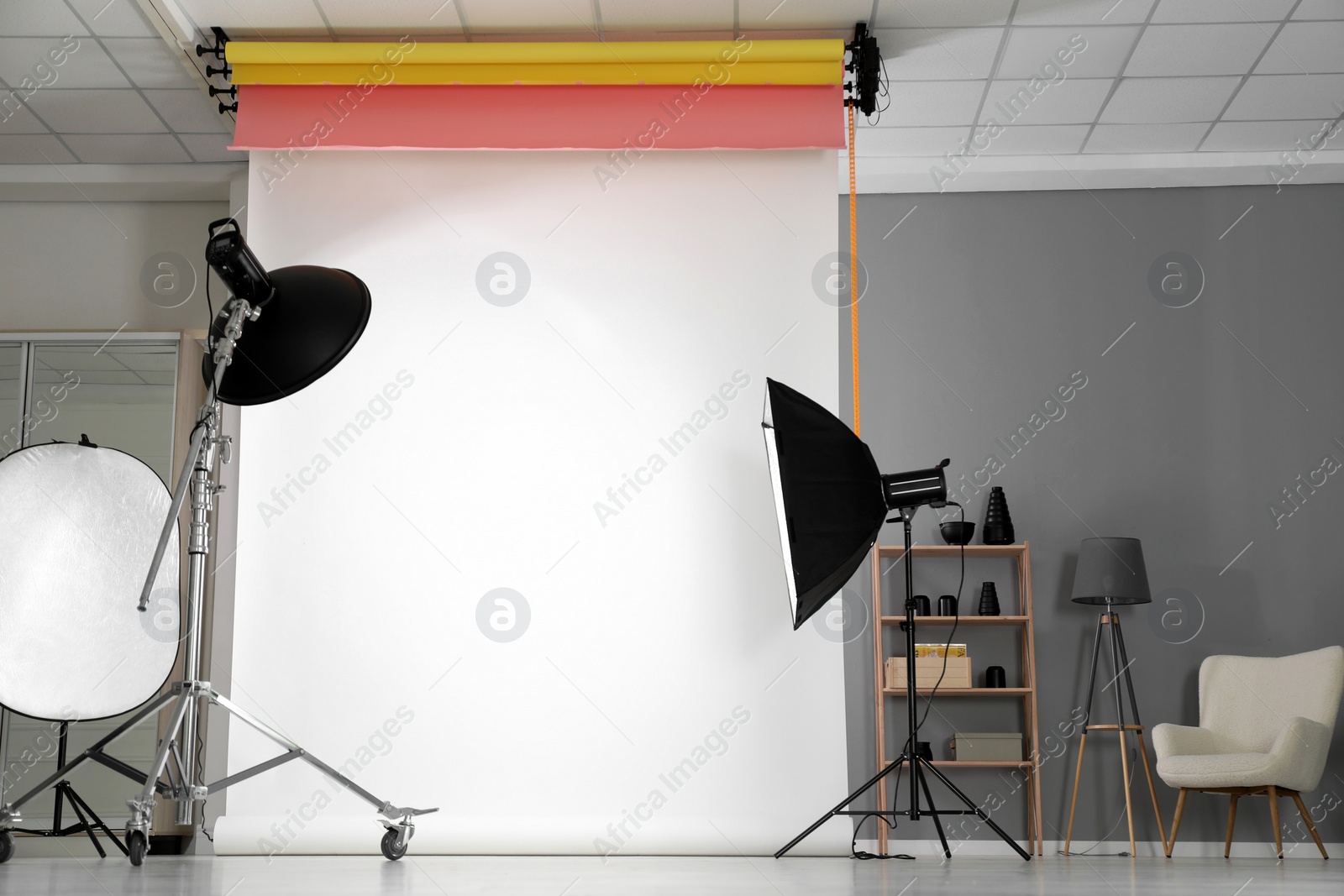 Photo of White photo background and professional lighting equipment in modern studio