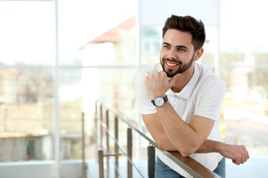 Photo of Portrait of handsome man smiling in light room