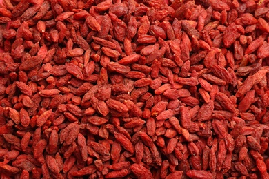 Photo of Many dried goji berries as background, top view. Healthy superfood
