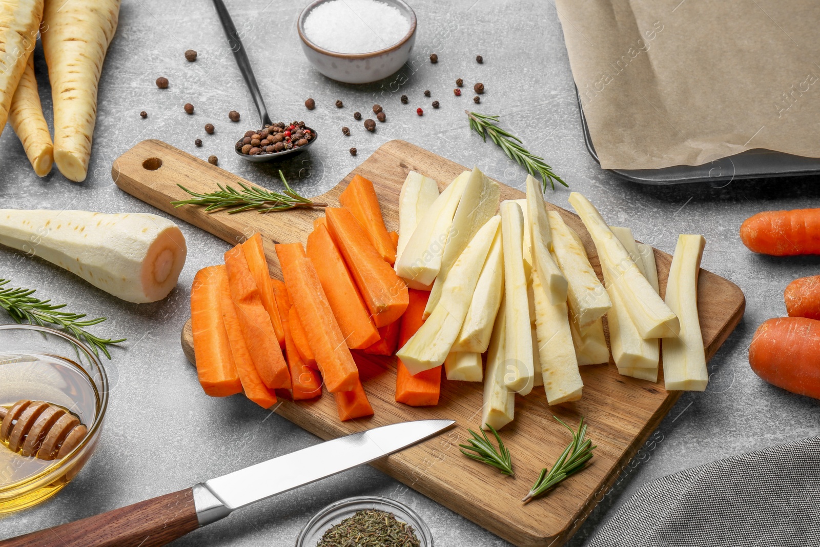 Photo of Composition with parsnips, carrots and other products on light grey table