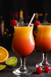 Photo of Fresh alcoholic Tequila Sunrise cocktails on grey table