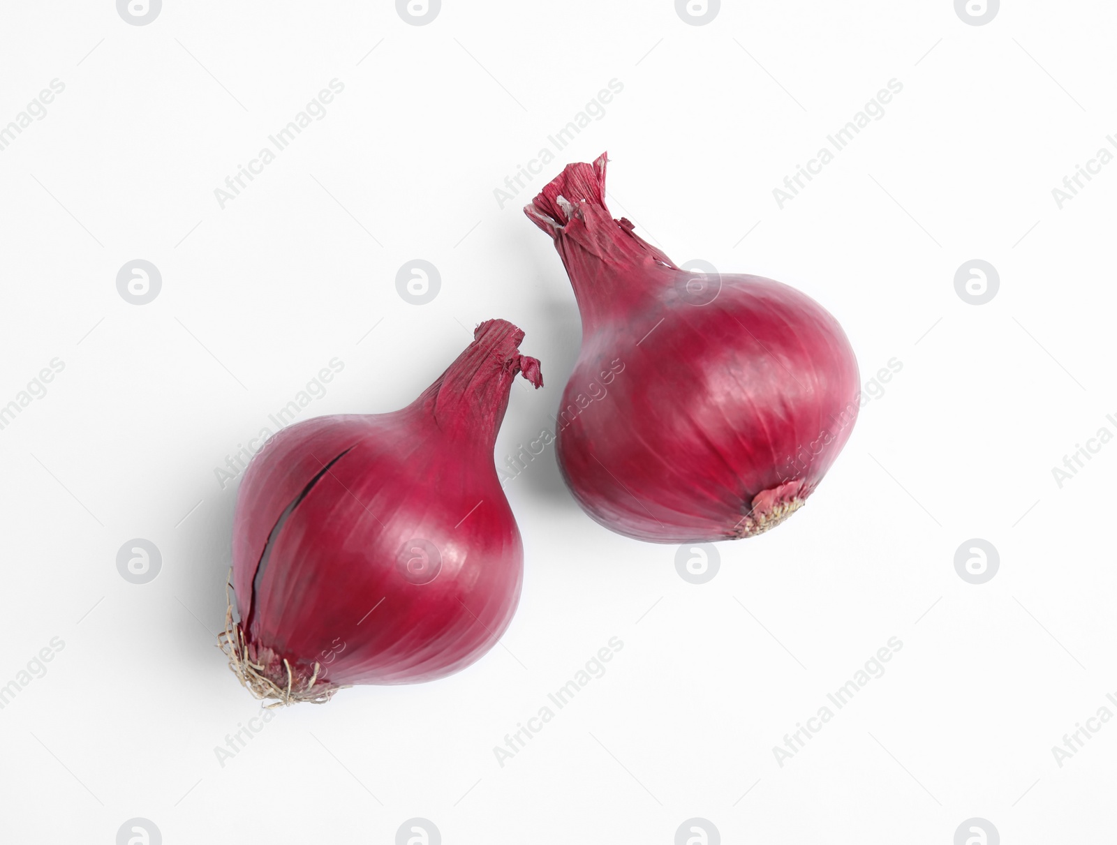 Photo of Ripe red onions on white background