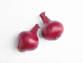 Photo of Ripe red onions on white background